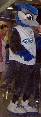 A mascot with a blue jay reminiscent head, and a human body.