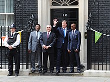 Cameron hosting a hunger summit with Pelé and Mo Farah outside 10 Downing Street