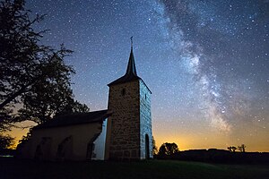 starry sky above a brick chapel
