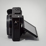 Sony Alpha ILCE-6000 APS-C-frame camera, side view, screen tilted