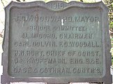 1916 plaque located in Piedmont Park and listing the mayor and members of a local bridge committee.