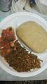 Eba and Efo riro (vegetable soup) with fish. Nigeria, 2014
