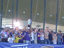 Maribor players celebrating their ninth league title on a podium