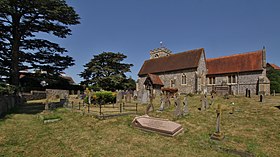 exterior of church and churchyard with residential building to the left