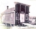 Herbert Radley stands in front of the original building, a carpentry shop, which was built in 1898 over the mill race of the Crystal River so the current could generate power. The shop was moved across the road around 1901, was painted white, and became the General Store - Then known as The Rural Store.