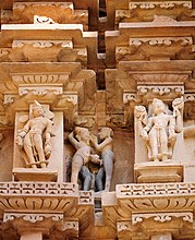 Erotic sculptures of two men (centre) at the Khajuraho temples.