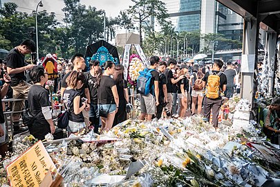 Mourners line up to present incense sticks and bow