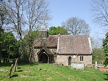 A small church seen from the south. On the left is the short nave on top of which is a bellcote with a pyramidal tower, and on the right is the chancel