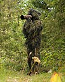 Wildlife photographer in a ghillie suit
