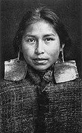 Kwaguʼł girl, Margaret Frank (nee Wilson) wearing abalone shell earrings. Abalone shell earrings were a sign of nobility and only worn by members of this class.
