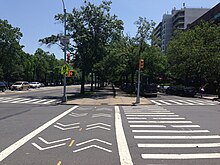 The western median as seen from Avenue C. There is a pedestrian and bicycle crossing across Avenue C in the foreground.