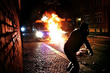 Protester in Copenhagen, Denmark hurling a molotov cocktail at police