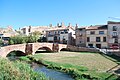 Old bridge over the Gallo river, 13th century, in the background the Medieval alcazar of Molina de Aragón, Spain.