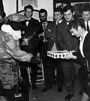 Sinterklaas party. A Zwarte Piet (a black pete, a joker chimney sweep) presents Underhill with a surprise gift, Utrecht Observatory, 1967