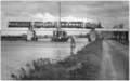 A train with an NS 7000 on the swing bridge over the Zijl near Leiden; circa 1930.