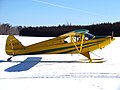 A Piper PA-12 Super Cruiser on skis at the Cobden, Ontario, Canada ski fly-in.