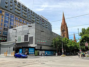 Colour photograph of a large concrete structure in a built up area