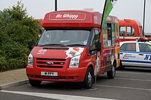 Red van decorated with pictures of different types of ice lolly which says "Mr Whippy" on the front of the roof