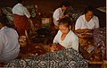 Batik craftswomen in Java handmarking resist on batik tulis cloth with tjantings