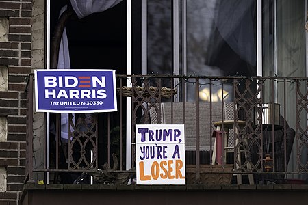 Biden Harris sign and Trump You're A Loser sign on an apartment balconey in Minneapolis, Minnesota