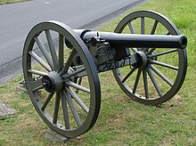 Photo shows a black Civil War era cannon with a thick band around the breech.