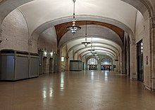Wide interior corridor with a vaulted ceiling