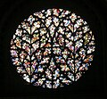 England Lincoln Cathedral, the Bishop's Eye. Fragments of ancient glass in a Flowing Gothic window.