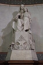 Christ with the Virgin Mary.by Joseph Lefèvre. On the base, the sculptures depict the tools of different professions.
