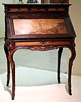 Desk (Art Nouveau), presented at the 1900 Paris Exposition; by Émile Gallé; 1900; molded and carved oak, with chiseled and patinated bronze; height: 108.5 cm; Musée d'Orsay (Paris)[68]