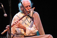A man playing bansuri