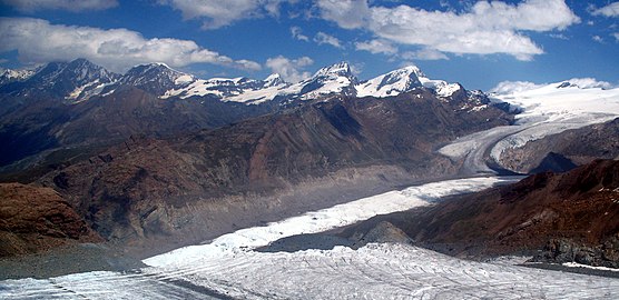 2007: The loss of thickness (about 200 m (660 ft)) of the lower Gorner Glacier since its major expansion in 1859 is recognizable on the south flank of the Gornergrat by the leftover and much higher lateral moraine (the light-coloured part above the grey flank); as seen from the Klein Matterhorn.