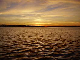 A body of water during sunset.