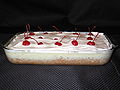 A Tres leches cake with cherries.