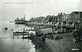 Piers supporting bandstand visible above beach, 1920s