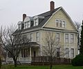 House with dormer windows and two brick chimneys