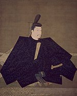 Portrait in three-quarter view of a person seated on the floor in courtly attire carrying a stick like object.