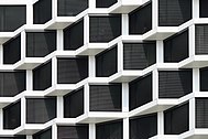 Facade of a modern residential building with automated blinds