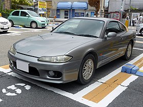 Front-three-quarter view of a two-door car with door mirrors