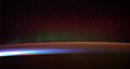 Image 42Earth's night-side upper atmosphere appearing from the bottom as bands of afterglow illuminating the troposphere in orange with silhouettes of clouds, and the stratosphere in white and blue. Next the mesosphere (pink area) extends to the orange and faintly green line of the lowest airglow, at about one hundred kilometers at the edge of space and the lower edge of the thermosphere (invisible). Continuing with green and red bands of aurorae stretching over several hundred kilometers. (from Earth)