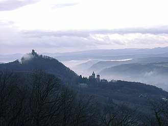 Dawn view from Petersberg into Rhine valley, showing the castle ruins on the Drachenfels and the Schloss Drachenburg