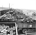 Drums of oil being transferred from rail cars to trucks, WWII