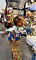 A woman selling water in Makola