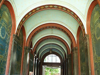Hallway crossing with frescoes on walls