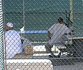 Detainees sit around the exercise yard in Camp 4, the medium security facility within Camp Delta at Naval Station Guantanamo Bay, Cuba.