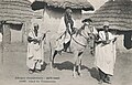 Guinea, circa 1905. Two griots accompany their lord, playing their instruments to announce his presence.