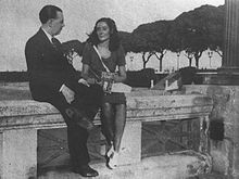 Black and white photograph of Jorge Luis Borges and Estela Canto sitting on a bench