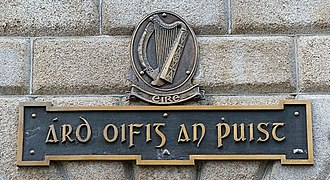 A sign on the external wall of the General Post Office, with the building's name (Irish: Árd Oifig an Phuist) in traditional Gaelic script and using an older spelling that predates Irish orthography reforms of the 1960s