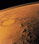 The southern rim of Argyre basin, formed by the Charitum Montes. Adjacent are sinuous ridges, theorized to be glacial eskers. The crater Galle is seen in the background.