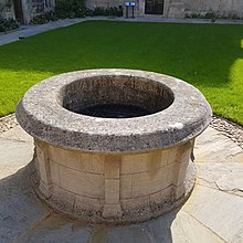 A picture of the well showing its Latin inscription reading "haurietis aquas in gaudio de fontibus salvatoris," which means "with joy, draw water from the wells of the Saviour."