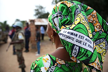 A Congolese woman asserts women's rights with the message 'The mother is as important as the father' printed on her pagne, 2015.